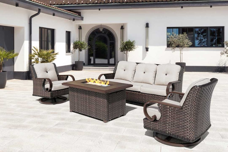 Outdoor patio set with fire pit table and chairs on a white patio.
